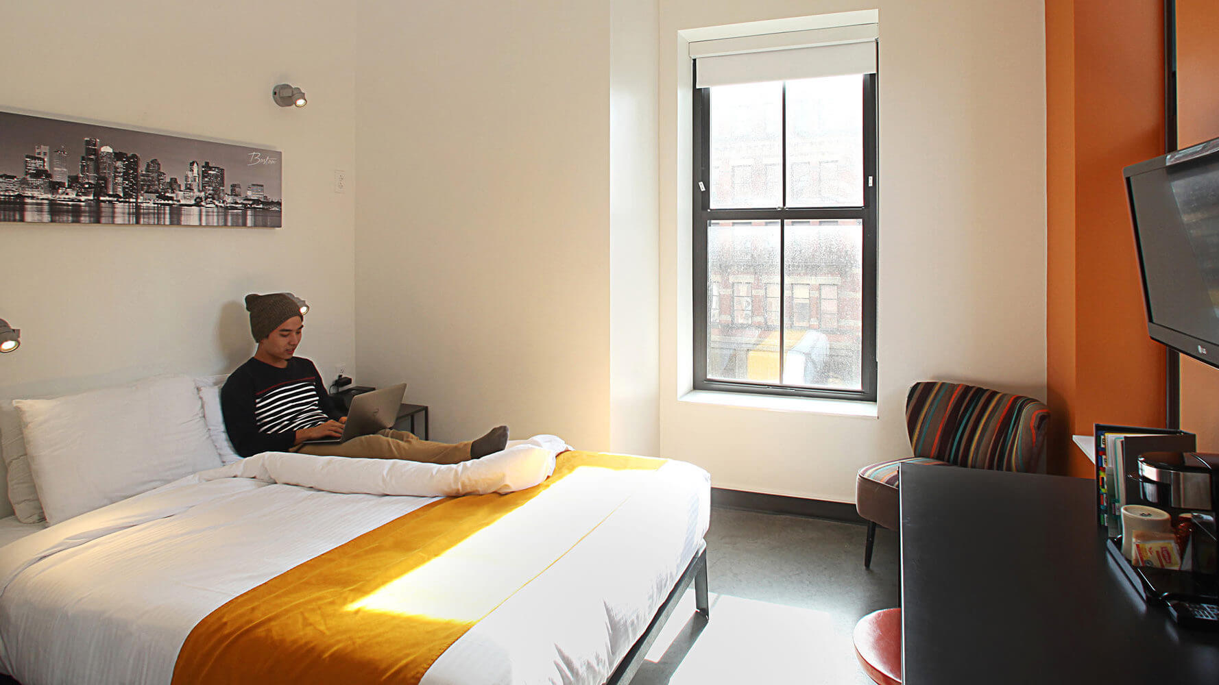 a cogito student relaxes in the hotel room we provide all students with while they stay in boston for thanksgiving break